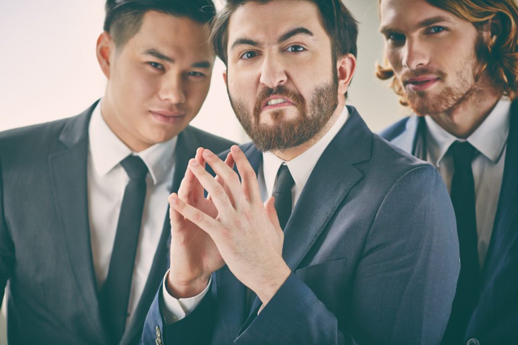 3 businessmen with evil expressions. Any of these men could be the villain in a learning story.